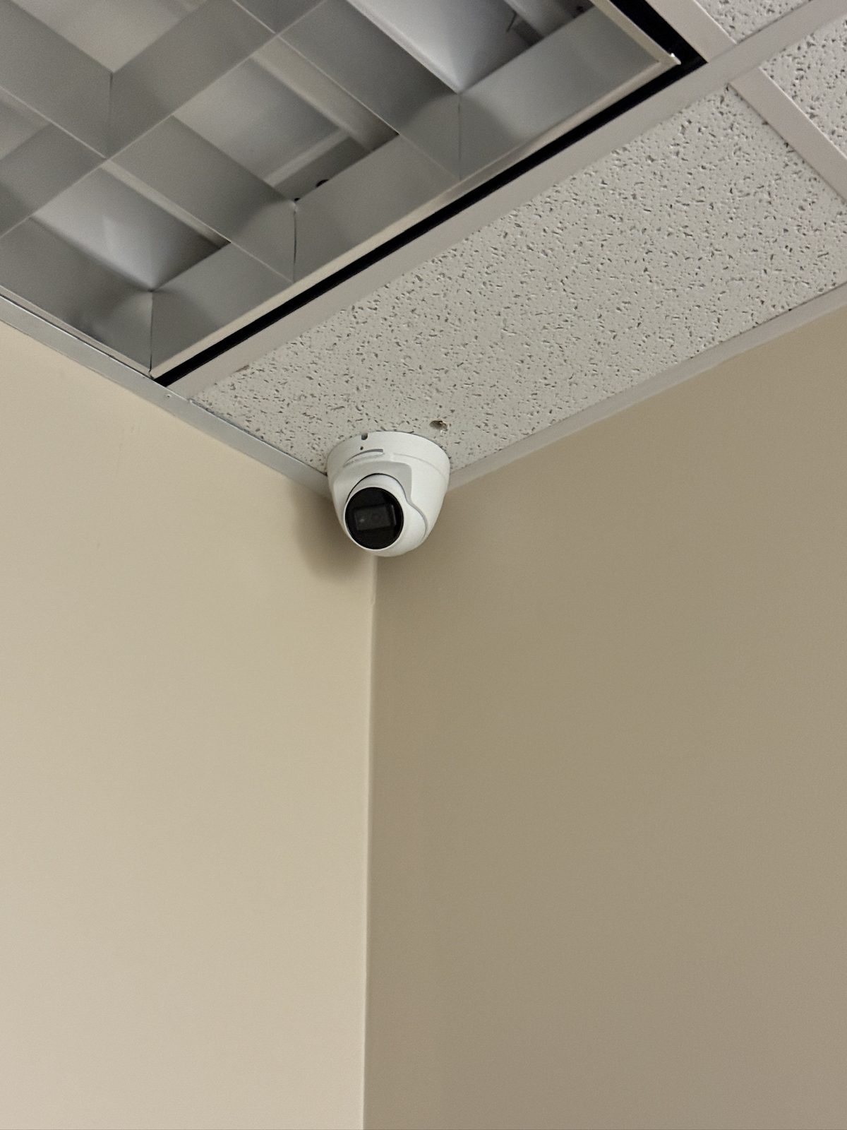 Interior camera positioned to watch an office entry and corridor.
