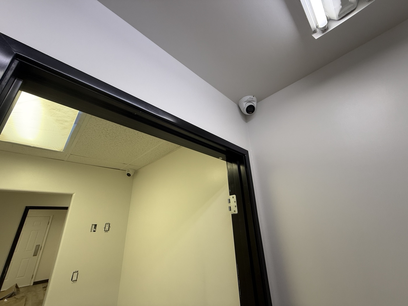 Two turret cameras installed around an interior dental office doorway.